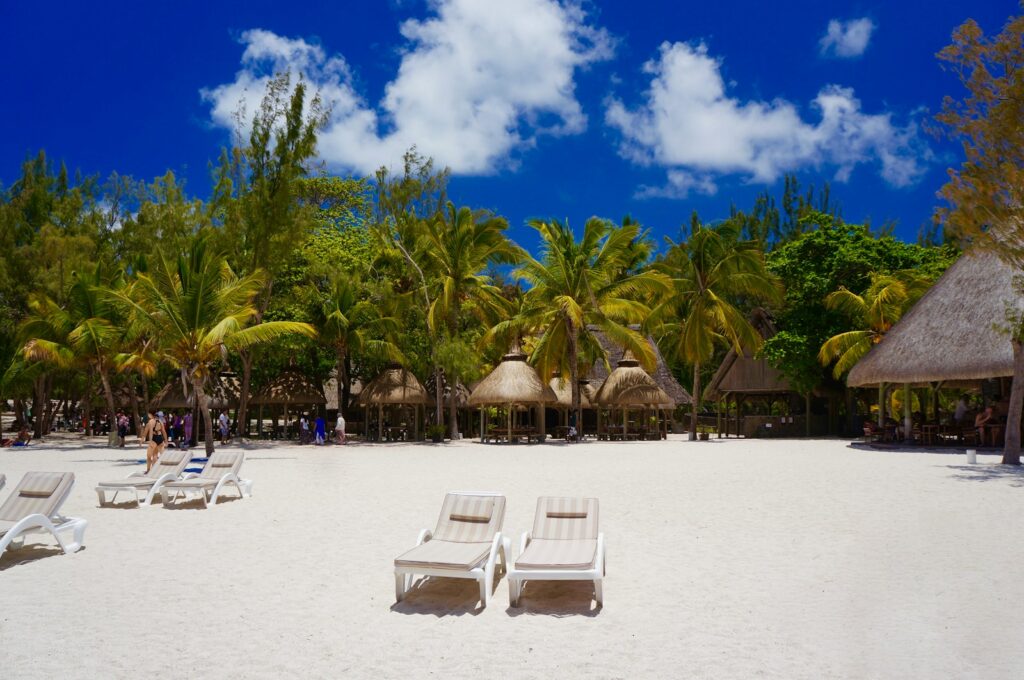two loungers near hut during daytime
