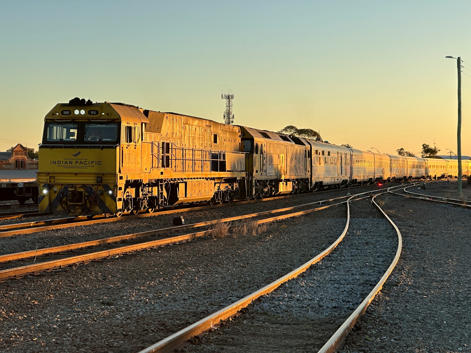 a train traveling down train tracks next to a train station