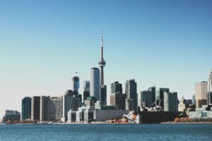 photo of high-rise buildings near body of calm water during daytime